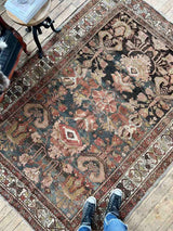 Person standingon a Hand-knotted vintage Persian rug