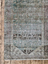 Teal vintage runner rug on a wooden floor
