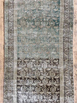 Vintage rug with geometric design on a wooden floor