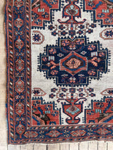 Antique Persian area rug close-up at Woven Kin Home