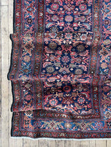 Colorful vintage Persian runner rug bunched up
