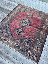 Antique Persian area rug with berry field, a floral border, and large medallions