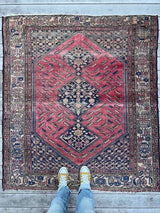 person standing on an Antique Persian area rug