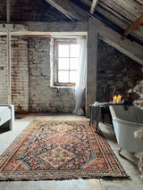 antique Persian area rug at Woven Kin Home sustainable home decor