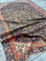 Antique Persian area rug with an allover motif on navy field