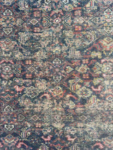 Close-up of an Antique Persian area rug with an allover motif on navy field