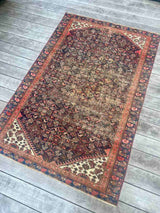 Antique Persian area rug with an allover motif on navy field