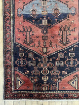 Vintage Persian Saveh rug with dusty pink and blue medallions and a navy field