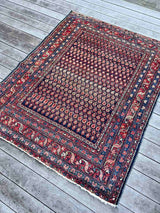Antique Persian area rug with multi-colored boteh motifs and a blue and red border