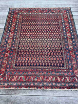 Antique Persian area rug with multi-colored boteh motifs