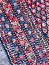 Close-up of the border motif of an Antique Persian area rug