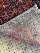 Close-up of back of a Vintage Persian area rug with dyed spots