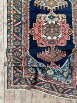 Colorful vintage area rug on a wooden floor