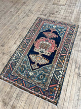 Colorful vintage area rug on a wooden floor