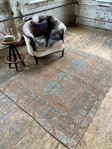 antique Persian area rug at Petrichor Vintage Co.