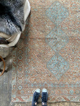 antique Persian area rug at Petrichor Vintage Co.