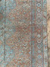 antique Persian area rug at Petrichor Vintage Co.