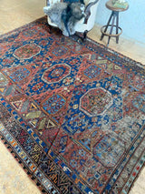 antique Caucasian area rug at Petrichor Vintage Co.