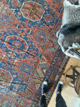antique Caucasian area rug at Petrichor Vintage Co.