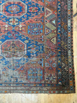 antique Caucasian area rug at Petrichor Vintage Co.