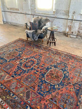 antique Caucasian area rug at Petrichor Vintage Co.
