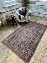 antique Persian area rug at Petrichor Vintage Co.