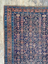 antique Persian area rug at Petrichor Vintage Co.