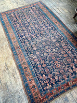 antique Persian area rug at Petrichor Vintage Co.