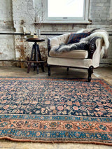 antique Persian area rug at Petrichor Vintage Co.