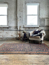antique Persian area rug at Petrichor Vintage Co.