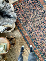 antique Persian area rug at Petrichor Vintage Co.