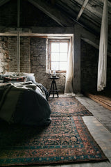 antique Persian area rug at Petrichor Vintage Co.