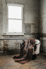 antique Persian area rug at Petrichor Vintage Co.