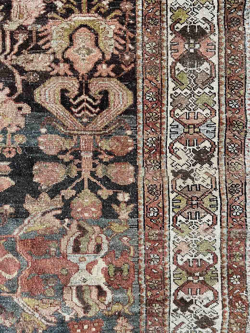 Hand-knotted vintage Persian rug with intricate border
