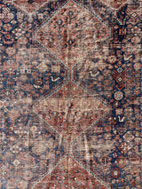 Close-up of a Hand-knotted antique Persian Afshar area rug with medallions and an allover animal motif