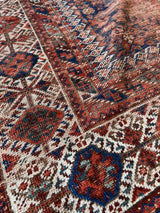 Close-up of the border of a hand-knotted antique Persian Afshar area rug 