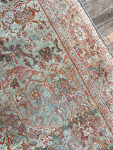 Close-up of the border of  a hand-knotted antique Persian Mahal area rug with allover botanical motifs on a celadon green field