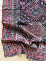 close-up of a corner of a Vintage Persian rug with colorful medallions