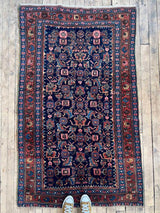 Antique Persian area rug birds-eye view at Woven Kin Home