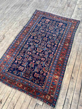 Antique Persian area rug full view at Woven Kin Home