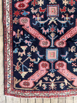 Vintage Caucasian Kuba accent rug with animal motifs and navy field