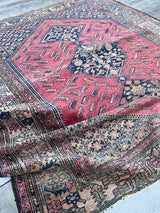 Antique Persian area rug  with berry field and large medallions draped across the floor