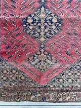 Close-up of an Antique Persian area rug  with berry field and large medallions