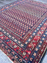 Antique Persian area rug with colorful boteh motifs