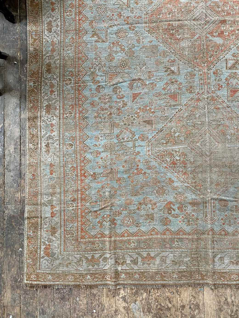 antique Persian area rug at Petrichor Vintage Co.