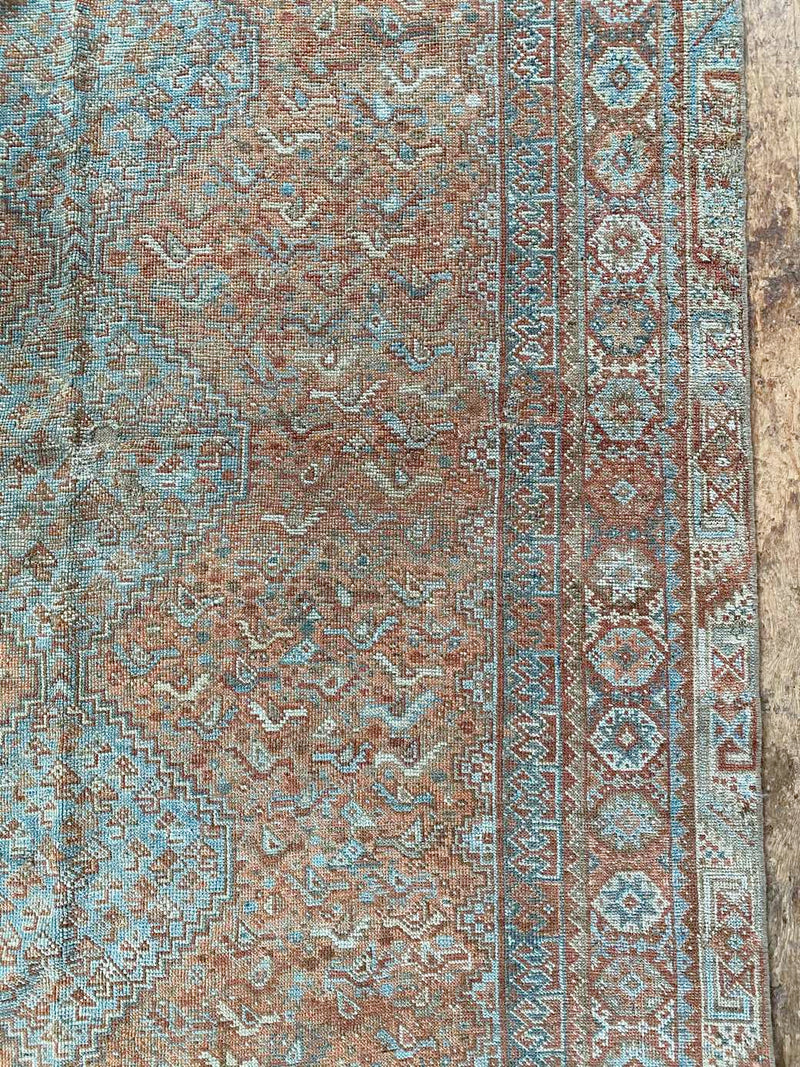 antique Persian area rug at Petrichor Vintage Co.